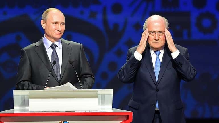 Vladimir Putin and FIFA President Sepp Blatter speak during the...