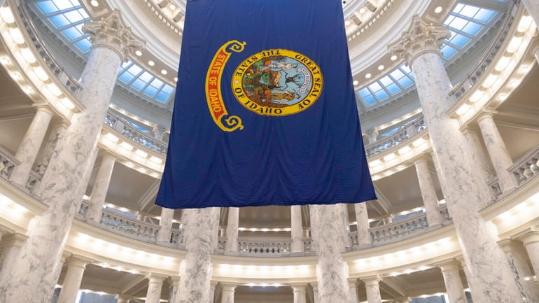 The Idaho state flag hangs in the State Capitol in...