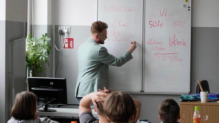 Arkadiusz Korporowicz teaches history to 5th grade children at Primary...