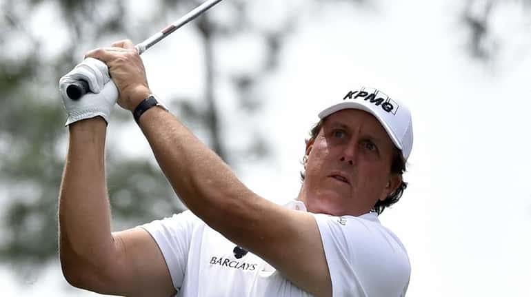 Golfer Phil Mickelson tees off during the par 3 contest...