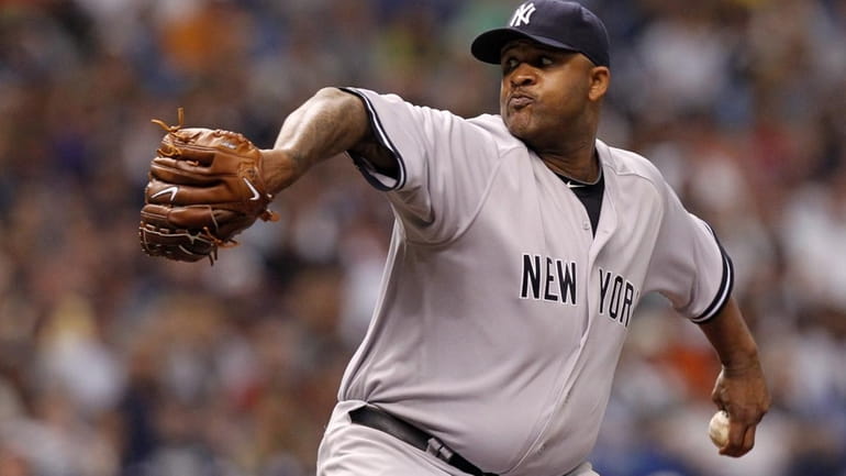 New York Yankees starting pitcher CC Sabathia throws in the...