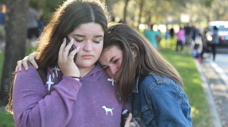 Students grieve outside Pines Trail Center after Wednesday's mass shooting...