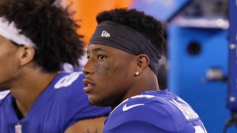 Giants running back Saquon Barkley sits on the bench during the...