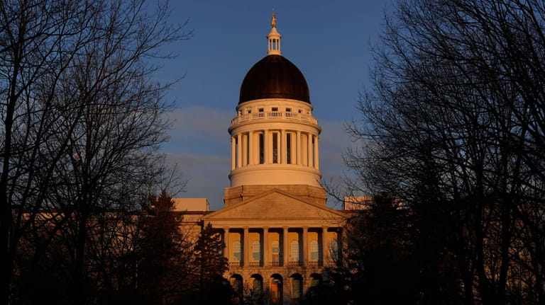 The Maine State House is seen at sunrise, March 16,...