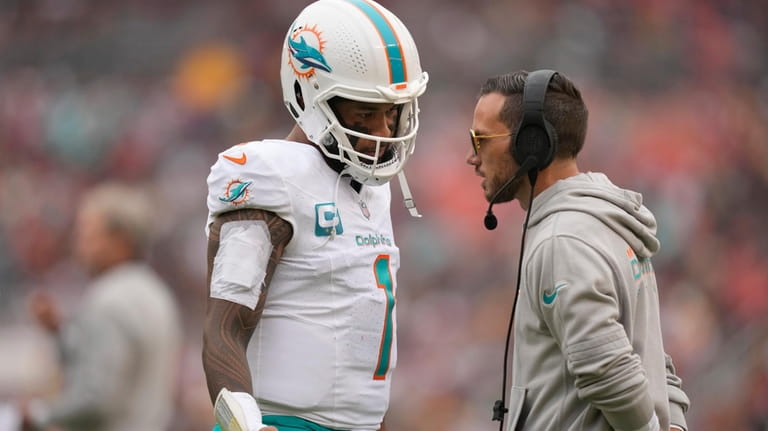 Miami Dolphins quarterback Tua Tagovailoa (1) talks with head coach...