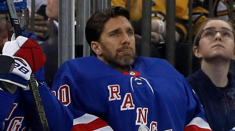Henrik Lundqvist of the Rangers looks on from the bench...