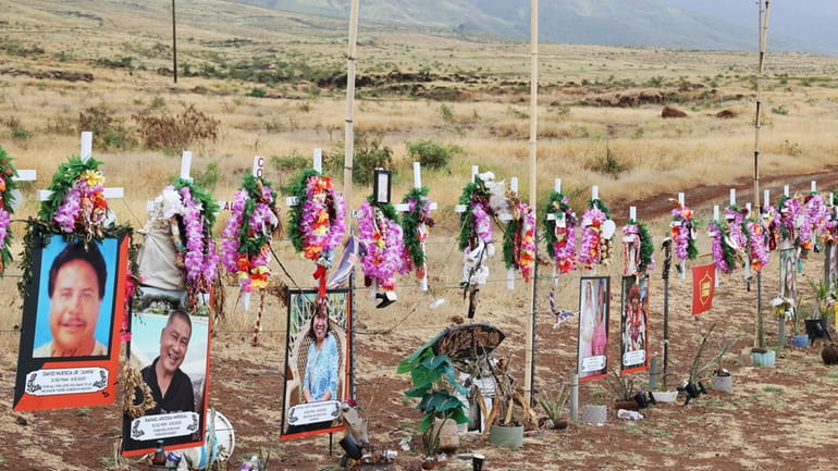 A roadside memorial dedicated to the Maui wildfires is seen,...