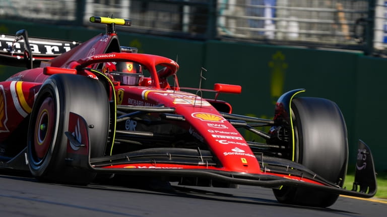 Ferrari driver Carlos Sainz of Spain steers his car during...
