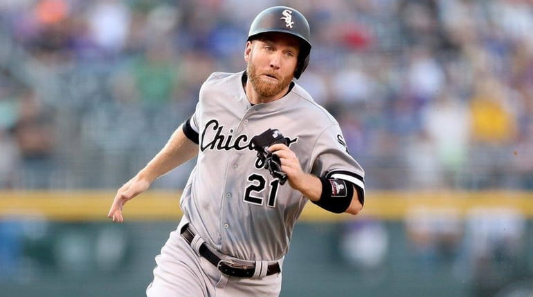 Todd Frazier #21 of the Chicago White Sox scores on...