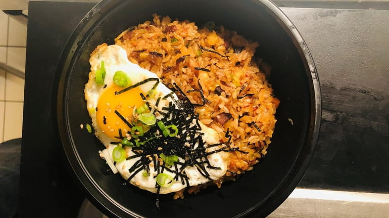 Kimchi fried rice with a sunny side up egg at...