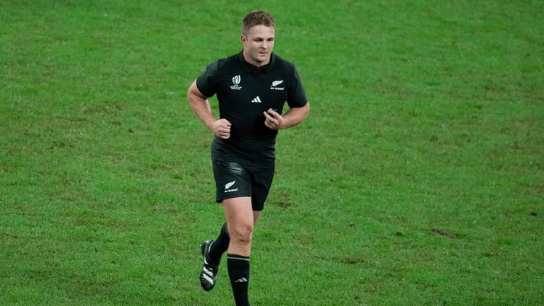 New Zealand's Sam Cane leaves the pitch after being shown...