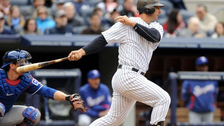 New York Yankees catcher Jorge Posada (20) hits a single...