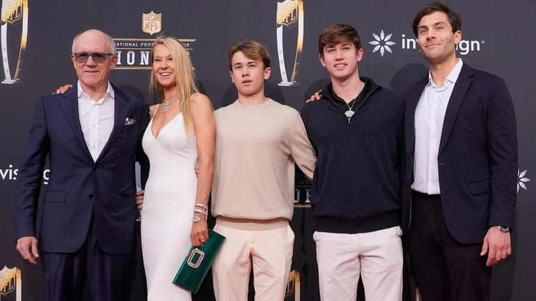 Jets owner Woody Johnson, left, poses with his family on...