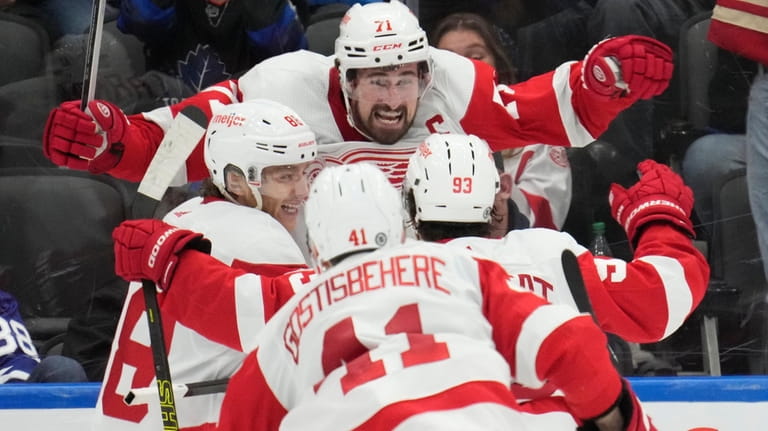 Detroit Red Wings centre Dylan Larkin (71) celebrates with teammates...