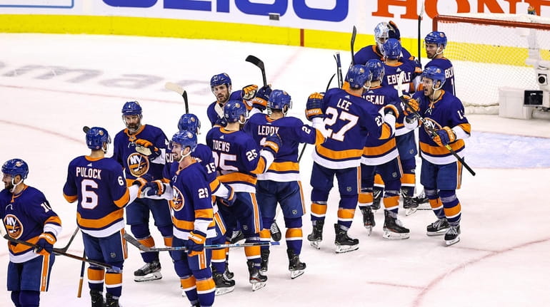 The Islanders celebrate their 3-2 victory against the Philadelphia Flyers in...