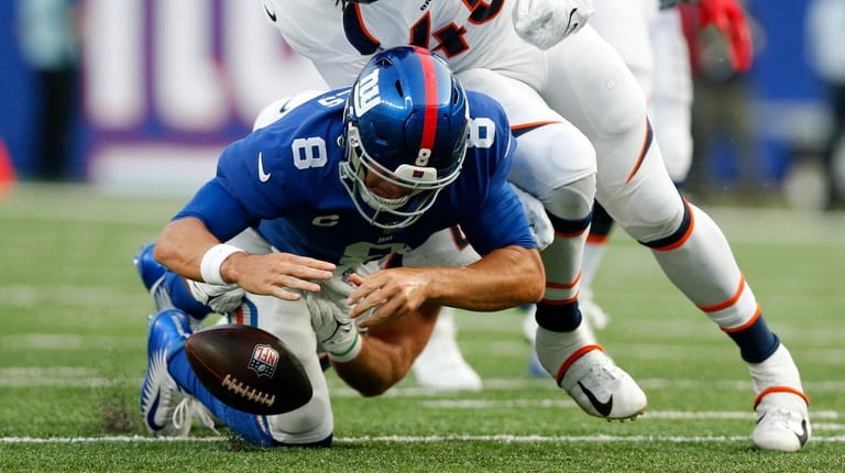 Daniel Jones #8 of the Giants fumbles the ball on a...