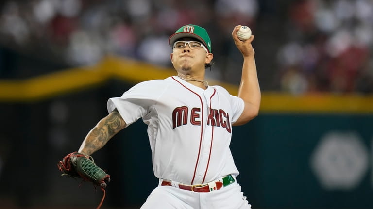 Mexico pitcher Julio Urías throws against Colombia during the first...
