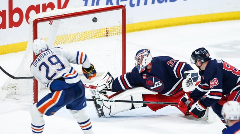 Edmonton Oilers' Leon Draisaitl (29) scores on Winnipeg Jets goaltender...