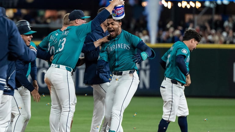 Seattle Mariners' Ty France empties a tub of bubble gum...