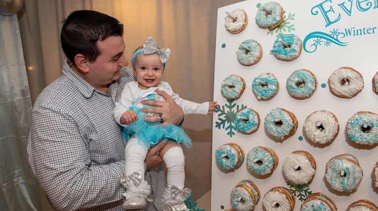 Everleigh, 1, and dad Matthew Leeb pose with a Winter...