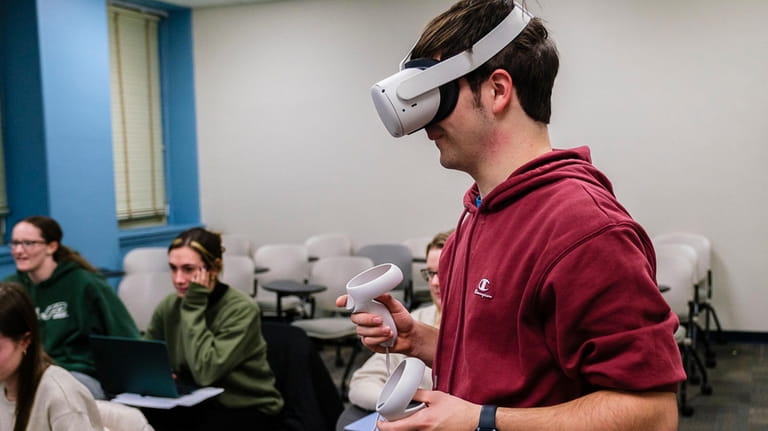 A Molloy student tries out a virtual reality headset last month in...