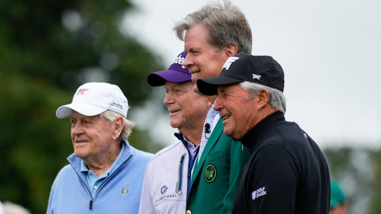 Augusta National chairman Fred S. Ridley, second from right, pose...