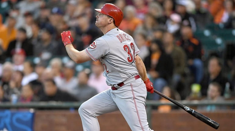 Jay Bruce #32 of the Cincinnati Reds swings and watches...