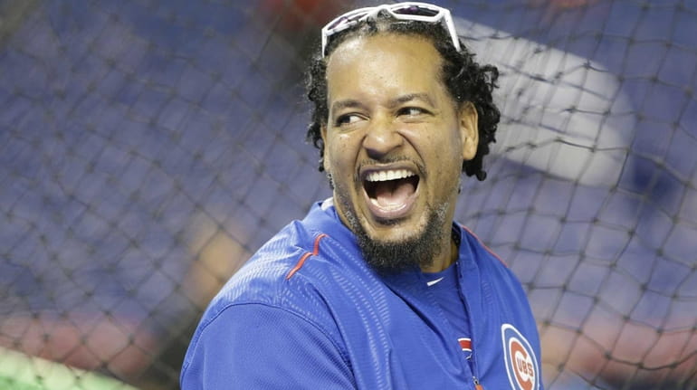 Chicago Cubs hitting consultant Manny Ramirez laughs as he watches...