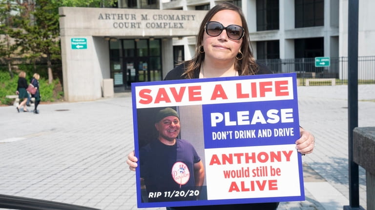Christie Azzolini, the fiancee of Anthony Mariano, at the Riverhead court...