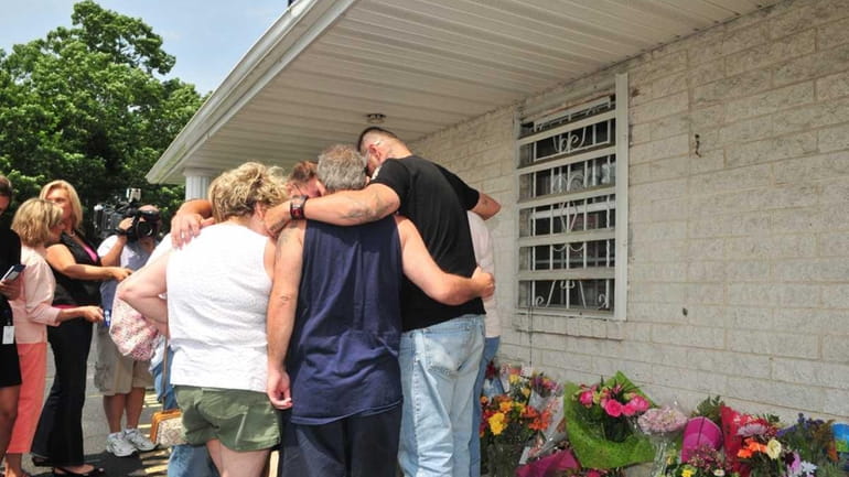 Family members of Jaime Taccetta console one another outside Haven...