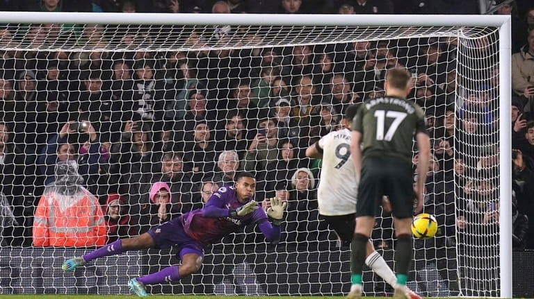 Fulham's Aleksandar Mitrovic sees his penalty saved by Southampton goalkeeper...