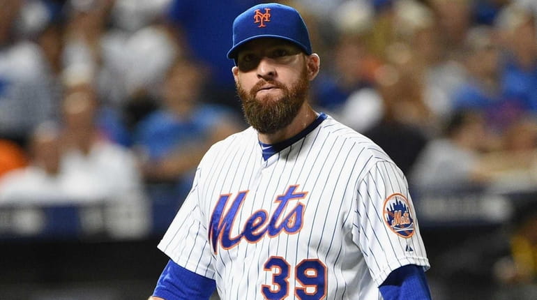 New York Mets relief pitcher Bobby Parnell walks to the...
