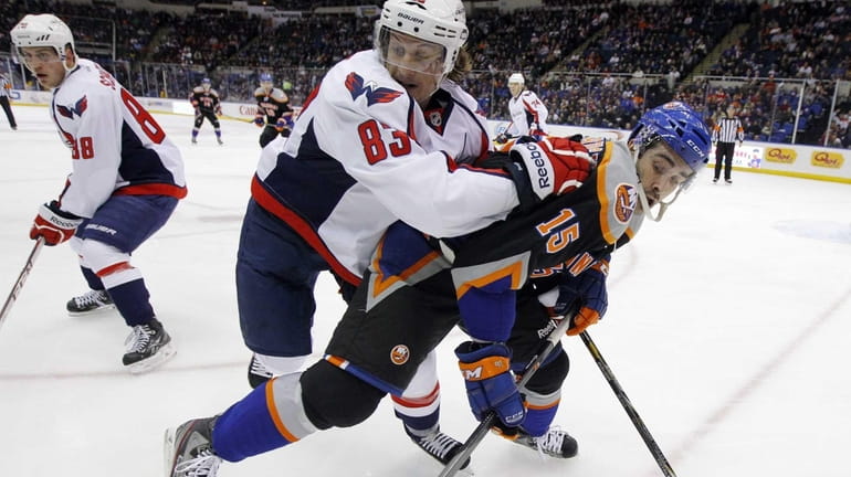 Islanders right wing Cal Clutterbuck battles for position during the...