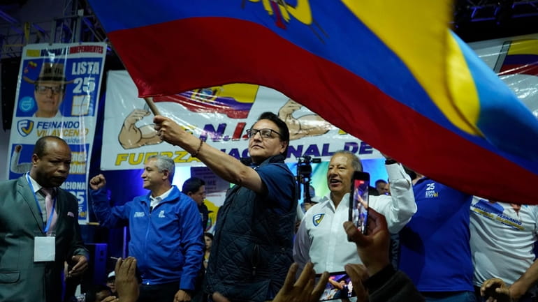 Presidential candidate Fernando Villavicencio waves a national flag during a...