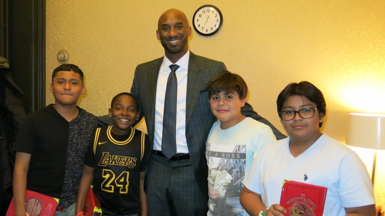 Retired NBA star Kobe Bryant with Kidsday reporters Humberto Guevara, left, Ian...