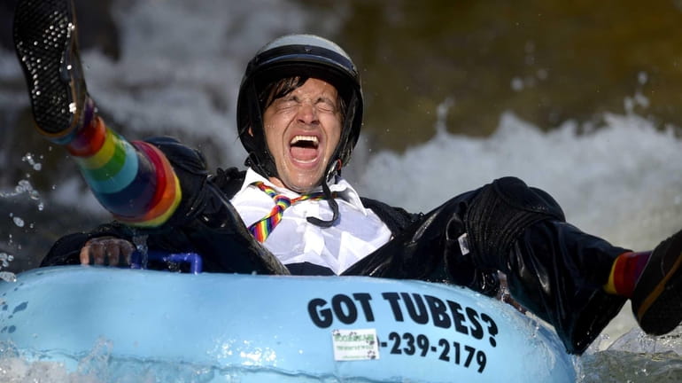 Co-founder Jeff Kagan laughs after crashing through rough water during...