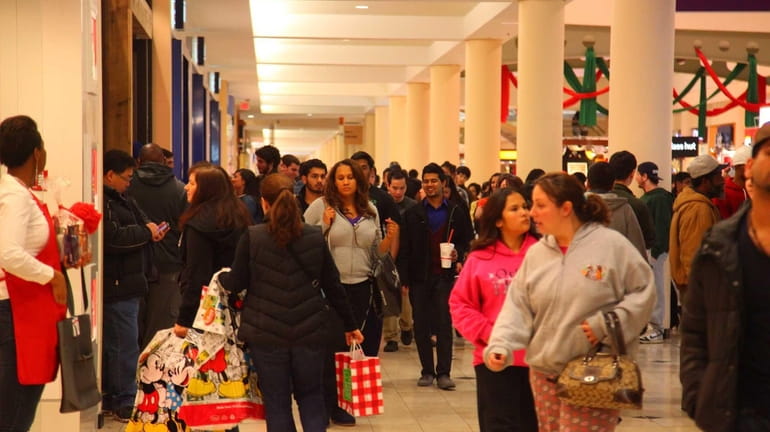 Shoppers fill the halls of the Roosevelt Field Mall as...