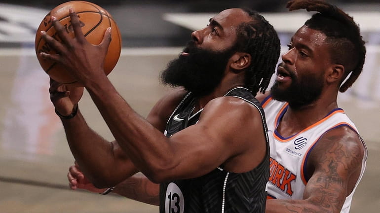 James Harden #13 of the Brooklyn Nets shoots against Reggie...