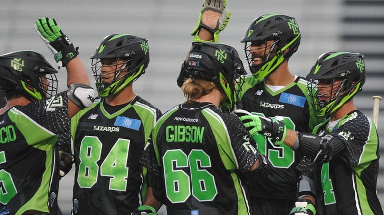 New York Lizards teammates celebrate after a goal by Paul...