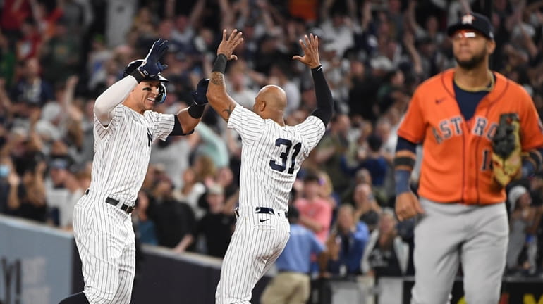 Yankees' Aaron Judge celebrates with Aaron Hicks after his walk-off...