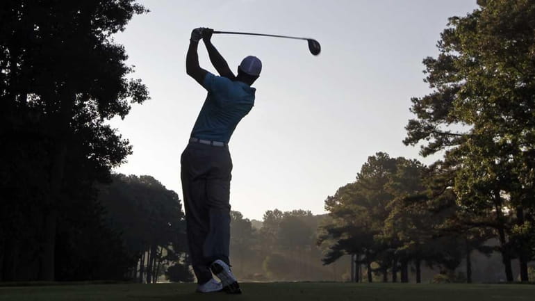 Tiger Woods hits a drive on the 12th hole during...