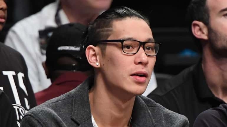 Brooklyn Nets guard Jeremy Lin looks on from the bench...