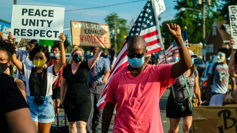 Demonstrators march in Baldwin on July 23, 2020 to protest...