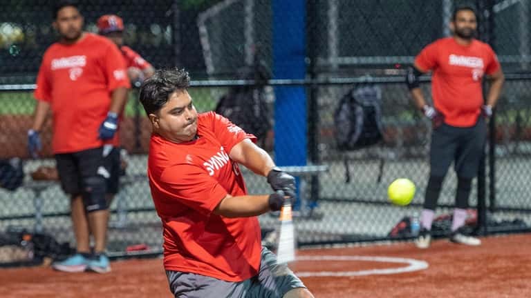 Nazmul Hasan makes contact in a Crescent Sports League softball...