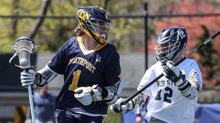 Northport's Michael Meyer works the ball behind the net, and...