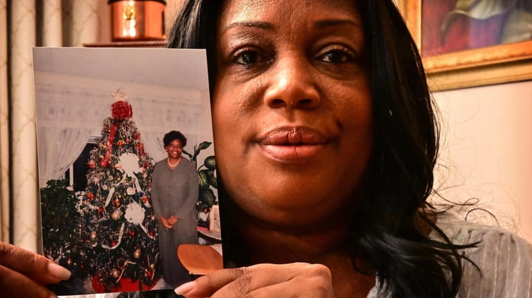 Nykiah Morgan, in her Westbury home, holds a photo of her...