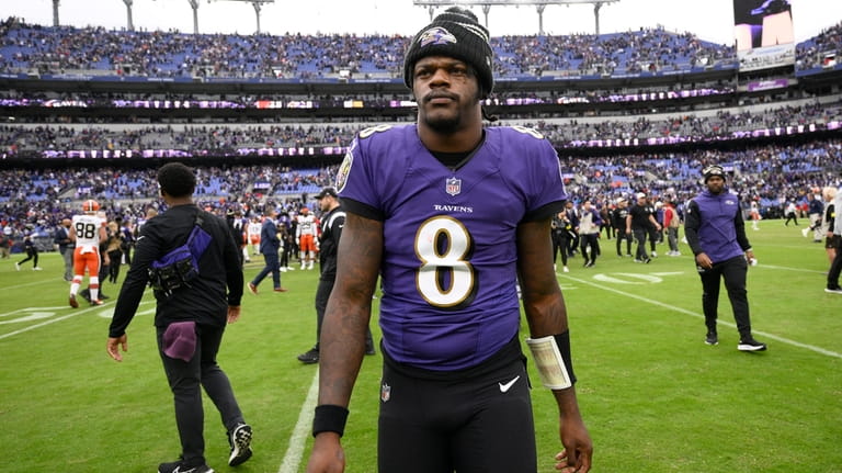 FILE - Baltimore Ravens quarterback Lamar Jackson (8) walks on...