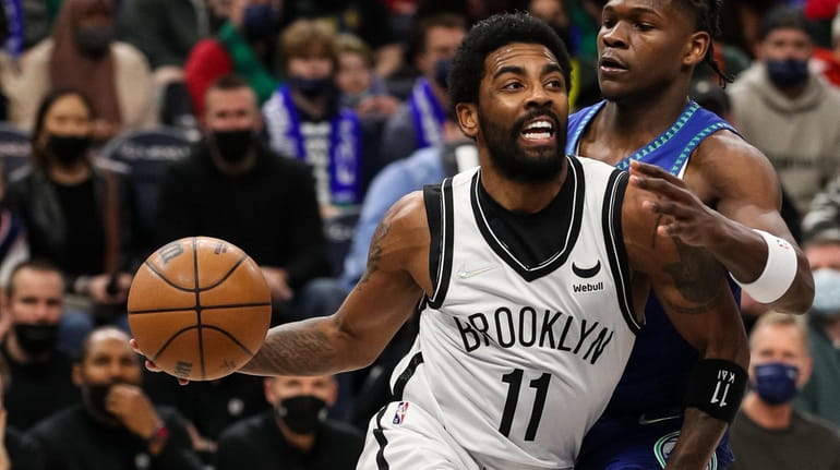 Kyrie Irving of the Brooklyn Nets is fouled by Anthony...