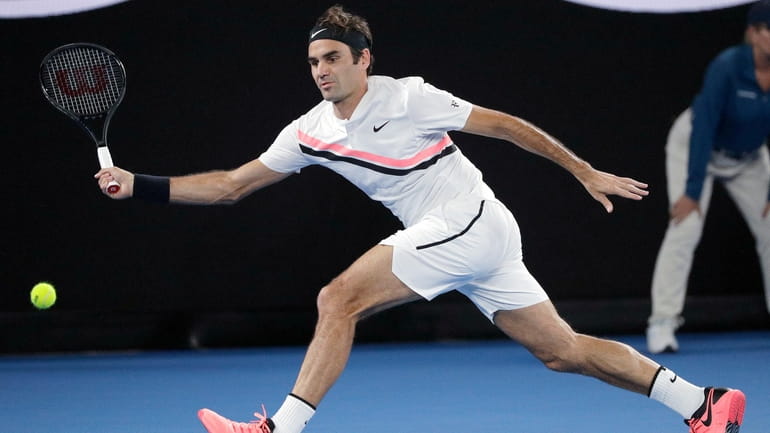 Switzerland's Roger Federer hits a forehand to Croatia's Marin Cilic...