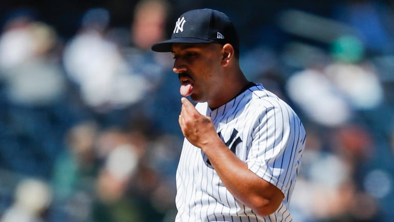 Yankees starting pitcher Nestor Cortes reacts during the eighth inning...
